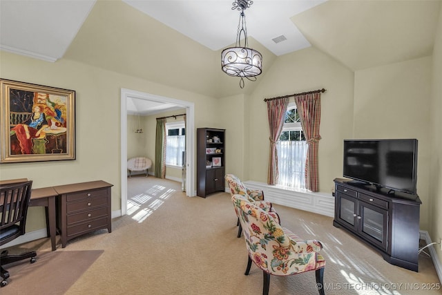 office with vaulted ceiling, a healthy amount of sunlight, and light carpet