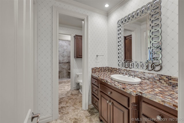 bathroom with crown molding, vanity, and toilet