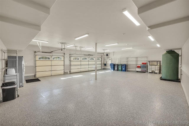 garage with a garage door opener and electric water heater