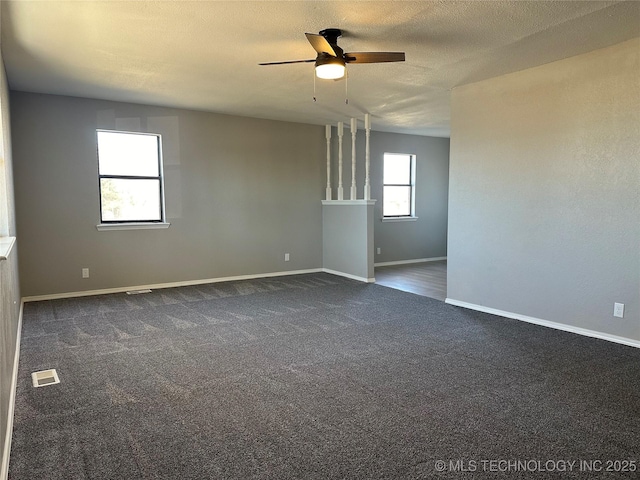 carpeted empty room with ceiling fan and a textured ceiling