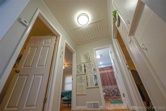 hallway featuring ornamental molding