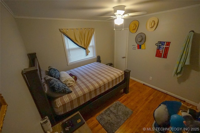 bedroom with crown molding, ceiling fan, and wood-type flooring