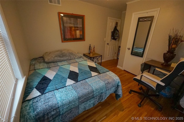 bedroom with wood-type flooring