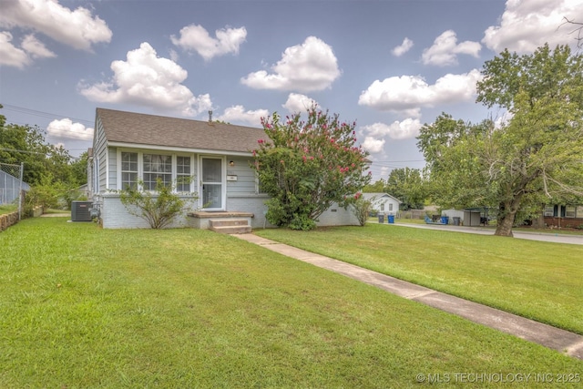 view of front of house featuring a front yard and central air condition unit