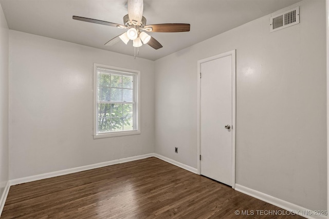 empty room featuring dark hardwood / wood-style floors and ceiling fan