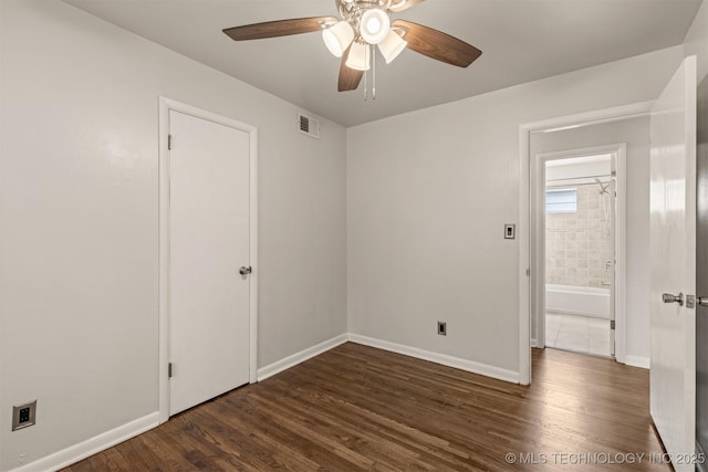 unfurnished room featuring ceiling fan and dark hardwood / wood-style flooring