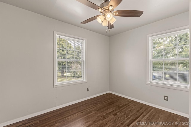 empty room with plenty of natural light, dark hardwood / wood-style floors, and ceiling fan