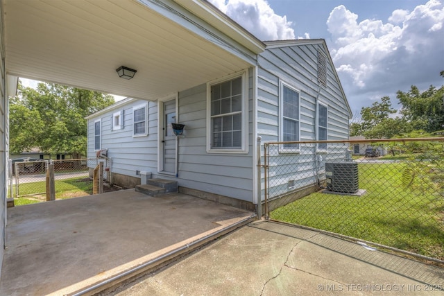 view of property exterior with central AC and a lawn