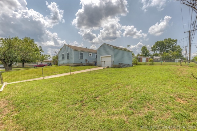 exterior space with a garage and a lawn