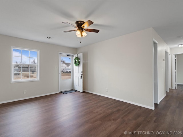 unfurnished room with dark wood-type flooring and ceiling fan