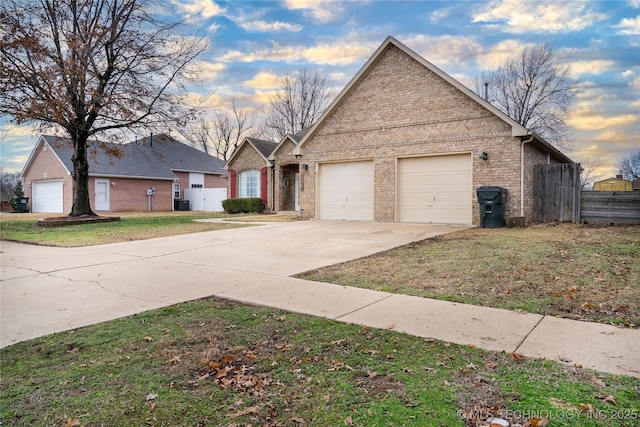 view of front of property featuring a garage and a lawn