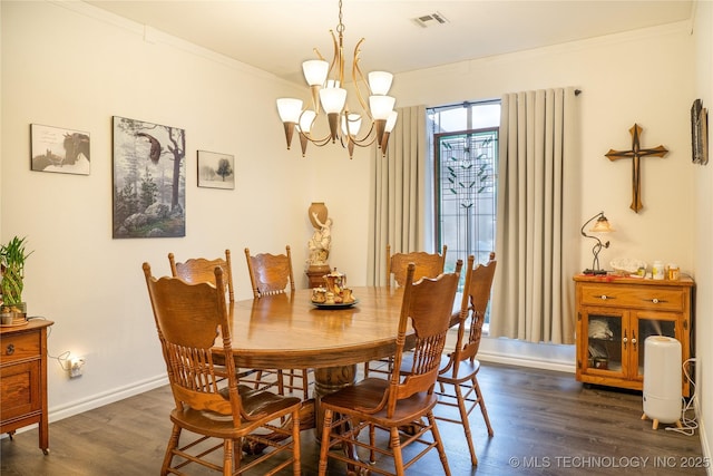 dining area featuring dark hardwood / wood-style flooring, a notable chandelier, and crown molding