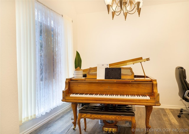 misc room featuring plenty of natural light, hardwood / wood-style floors, and a notable chandelier