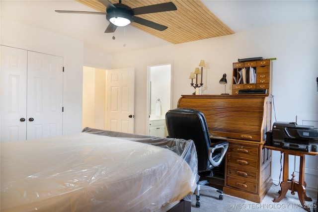 bedroom with ceiling fan, carpet floors, and a closet