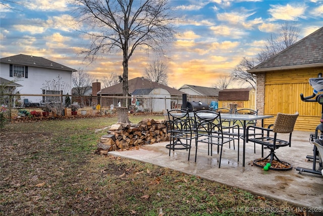 yard at dusk featuring a patio area