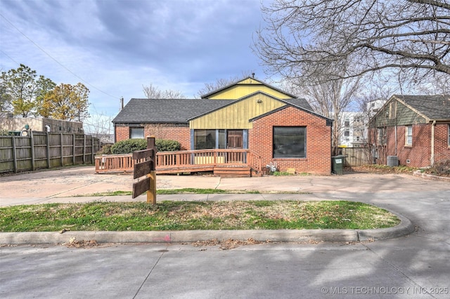 view of front of home with a wooden deck and central AC unit