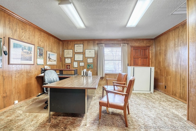 office area with light colored carpet, ornamental molding, a textured ceiling, and wood walls