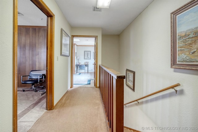 hall featuring light colored carpet