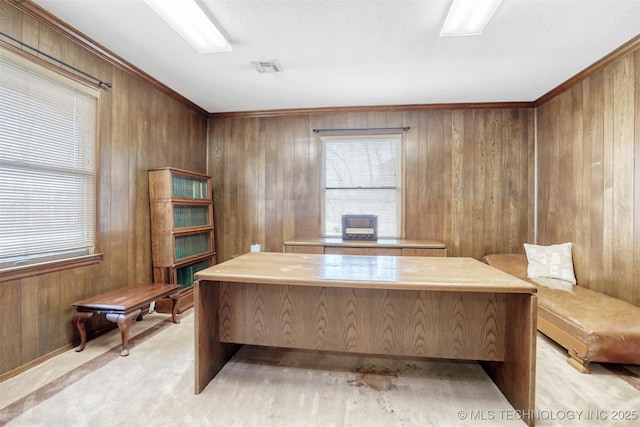 unfurnished office featuring crown molding, a wealth of natural light, wooden walls, and light colored carpet