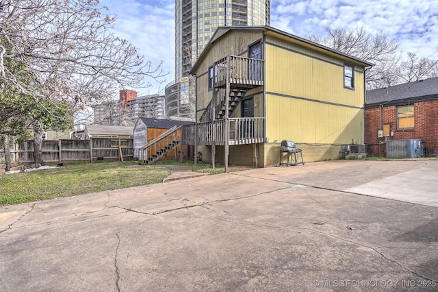 back of property featuring central air condition unit