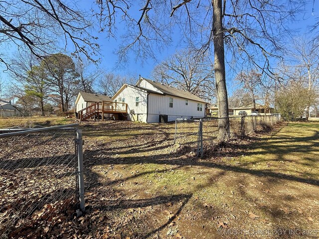 view of home's exterior with a deck and a lawn