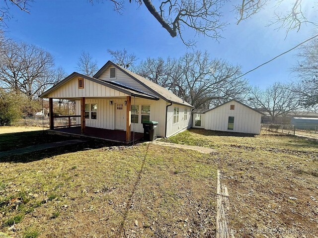 exterior space with a front yard and covered porch