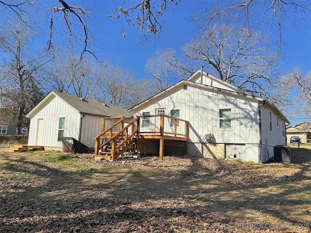 back of house with a deck, roof with shingles, board and batten siding, crawl space, and central AC unit