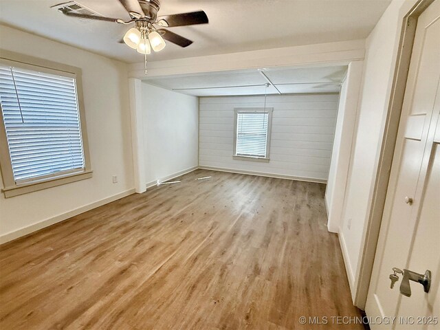 empty room featuring ceiling fan and light wood-type flooring