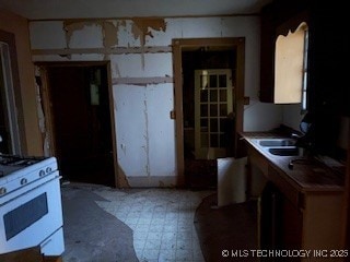 kitchen with sink and white range with gas stovetop