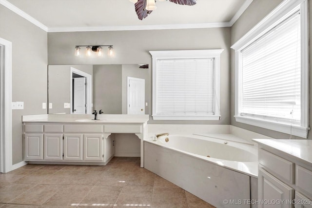 bathroom with a healthy amount of sunlight, ornamental molding, a bathing tub, and vanity