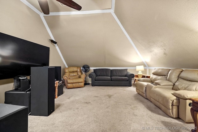 living room with ceiling fan, vaulted ceiling, and carpet