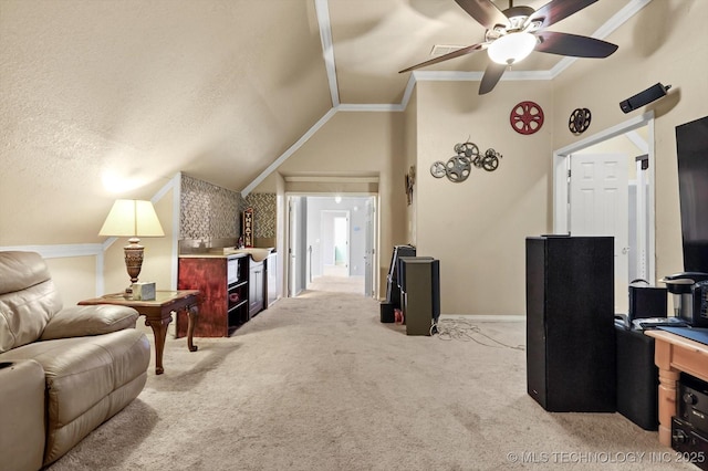 living room with lofted ceiling, crown molding, ceiling fan, a textured ceiling, and light colored carpet