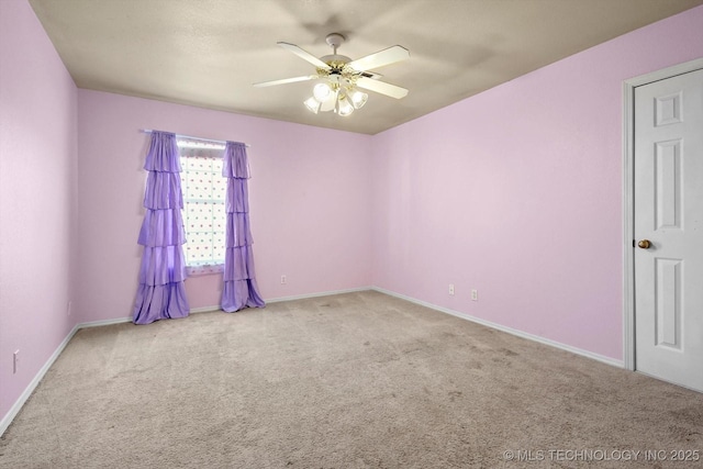 carpeted spare room with ceiling fan