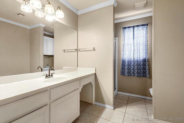 bathroom with vanity, ornamental molding, tile patterned floors, toilet, and walk in shower