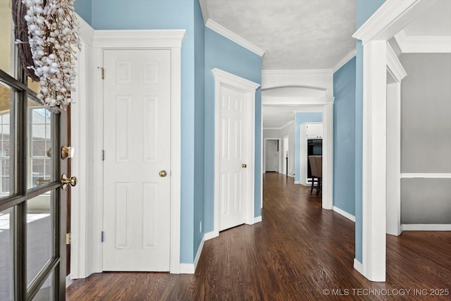 hallway with dark hardwood / wood-style flooring and crown molding