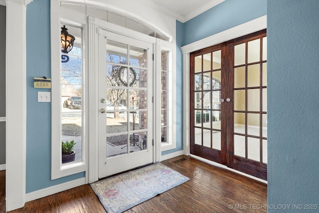 entryway with french doors, crown molding, and dark wood-type flooring