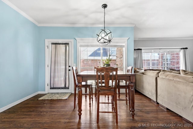 dining area with ornamental molding, dark wood-type flooring, and an inviting chandelier