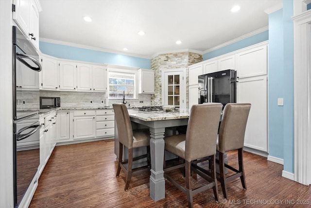 dining space with ornamental molding and dark hardwood / wood-style flooring