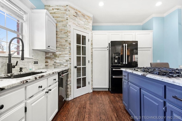 kitchen with blue cabinetry, sink, white cabinetry, crown molding, and appliances with stainless steel finishes