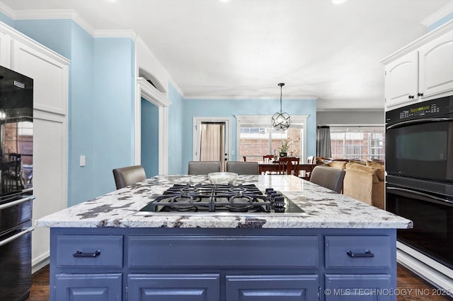 kitchen with white cabinetry, blue cabinetry, stainless steel gas stovetop, and double oven