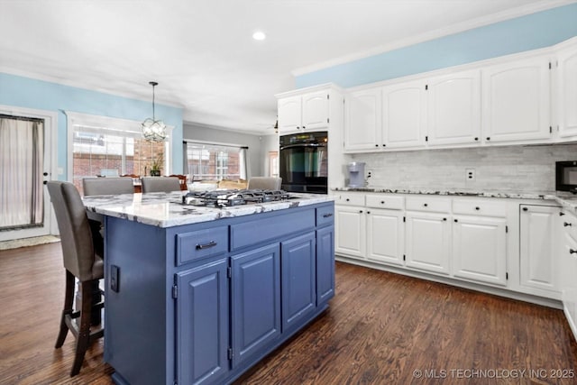 kitchen featuring decorative light fixtures, white cabinets, and black appliances