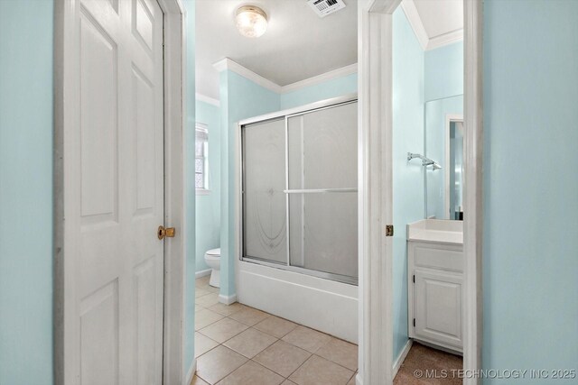 full bathroom with tile patterned floors, toilet, crown molding, shower / bath combination with glass door, and vanity