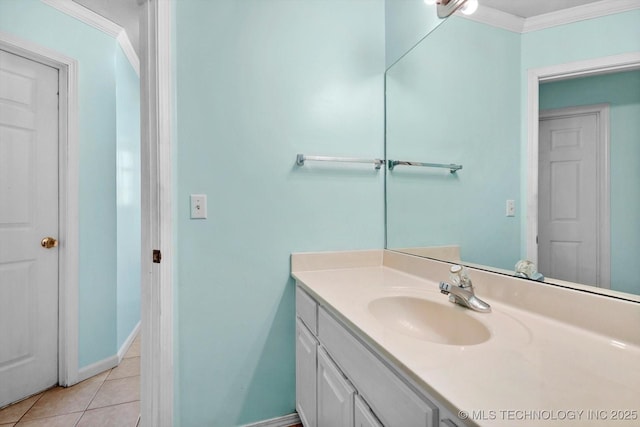 bathroom featuring tile patterned flooring, vanity, and crown molding