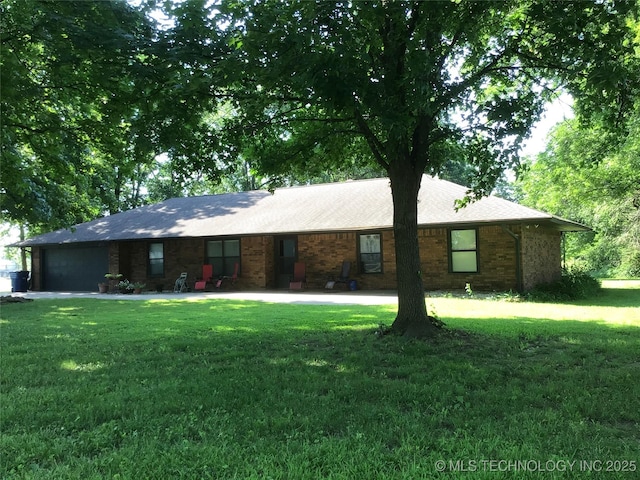 ranch-style house featuring a garage and a front yard