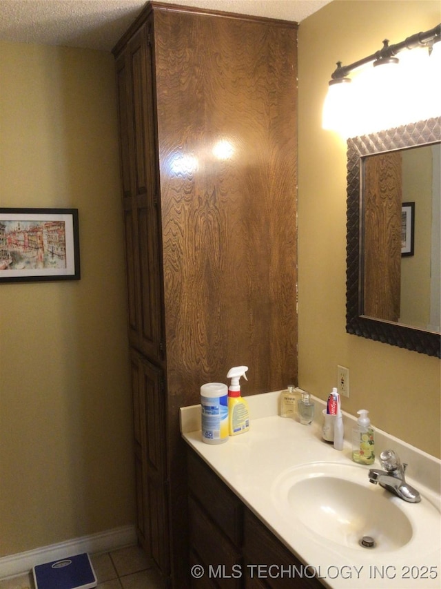 bathroom with vanity, tile patterned flooring, and a textured ceiling