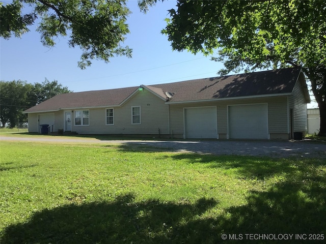 single story home featuring a garage and a front lawn