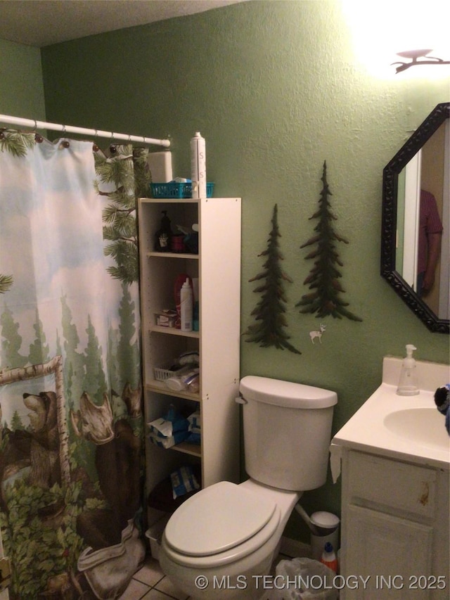 bathroom featuring vanity, tile patterned flooring, and toilet