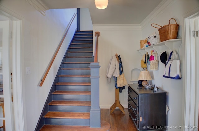 staircase featuring crown molding and hardwood / wood-style flooring