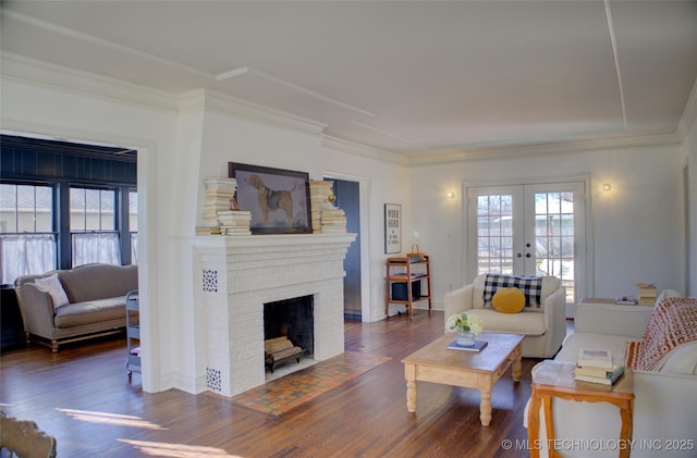 living room featuring french doors, a fireplace, ornamental molding, and dark hardwood / wood-style floors