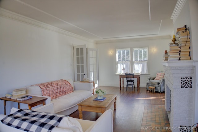 living room with crown molding, a brick fireplace, and dark wood-type flooring